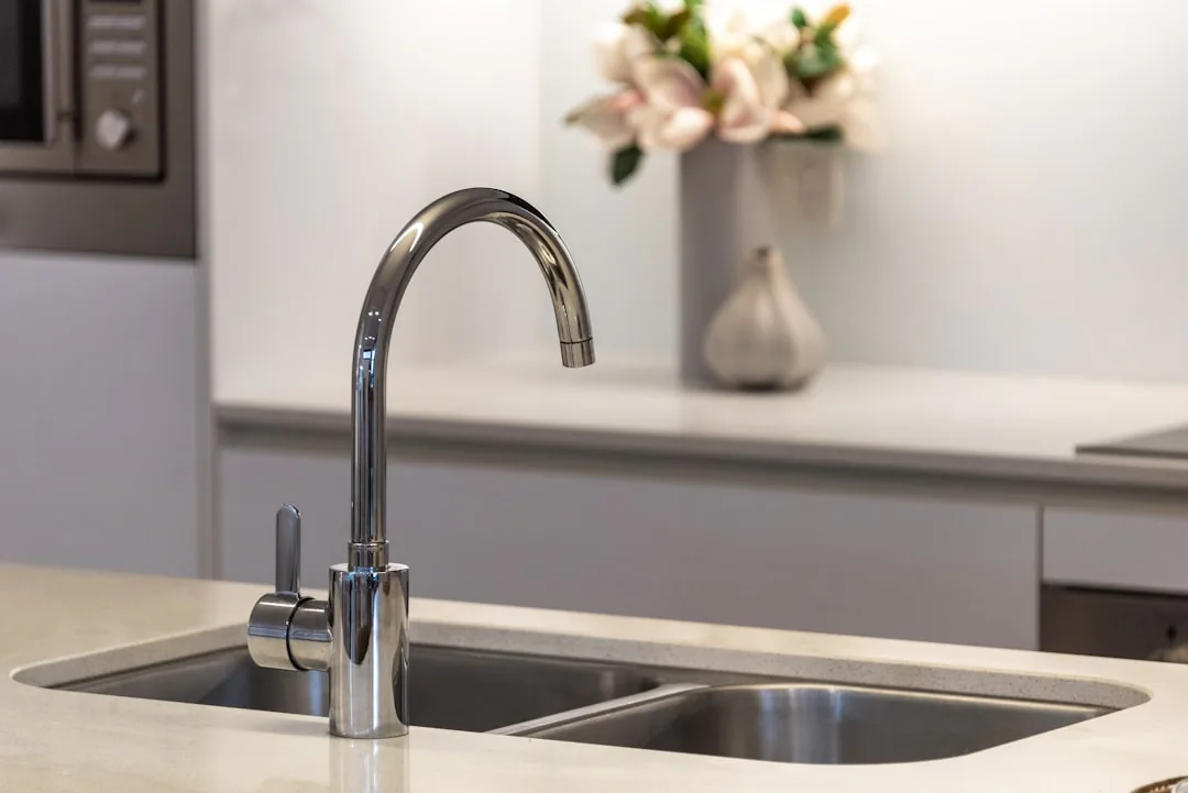 Stainless steel kitchen sink tap close up