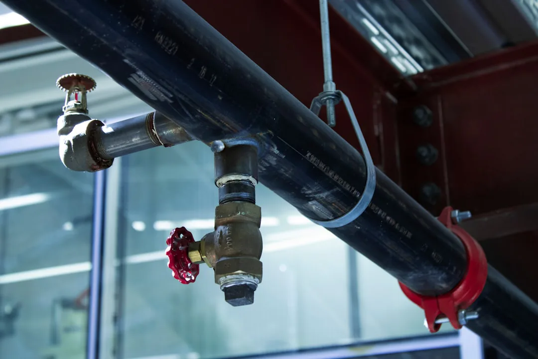 Grey pipe fittings connected to building structure